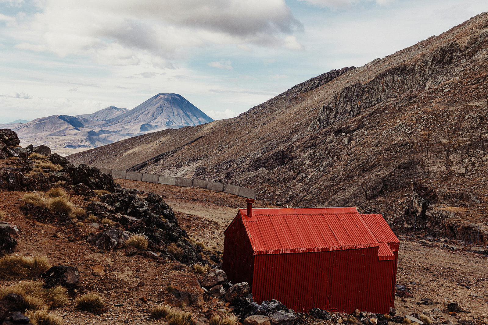 Red backcountry hut with Mt Ngauruhoe in the distance, Tongariro National Park
